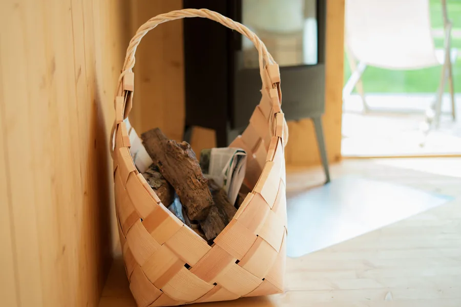A basket of firewood ready beside Zen's warm timber interior